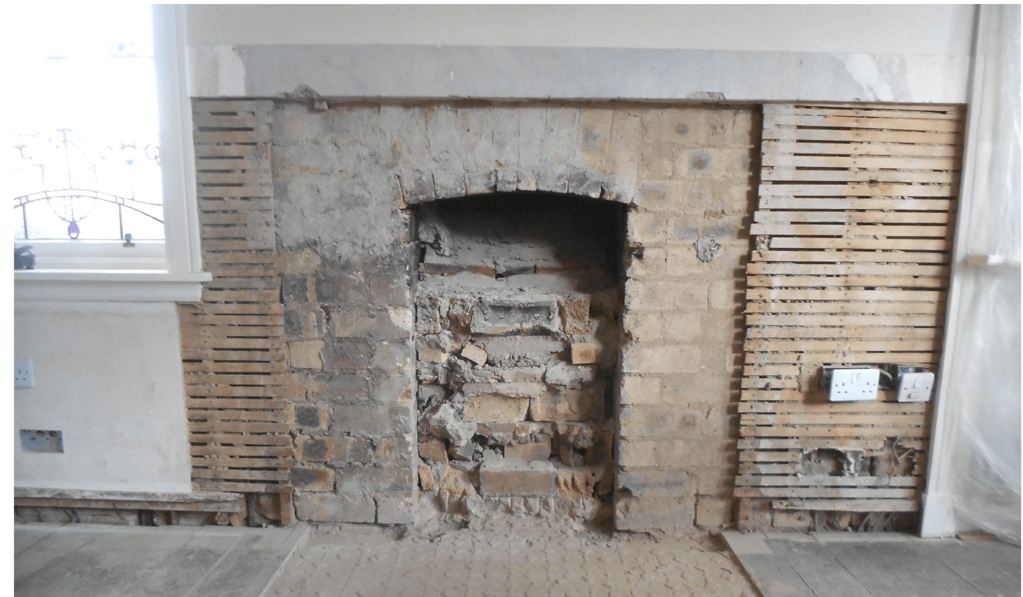 fireplace being removed with mortar surrounding